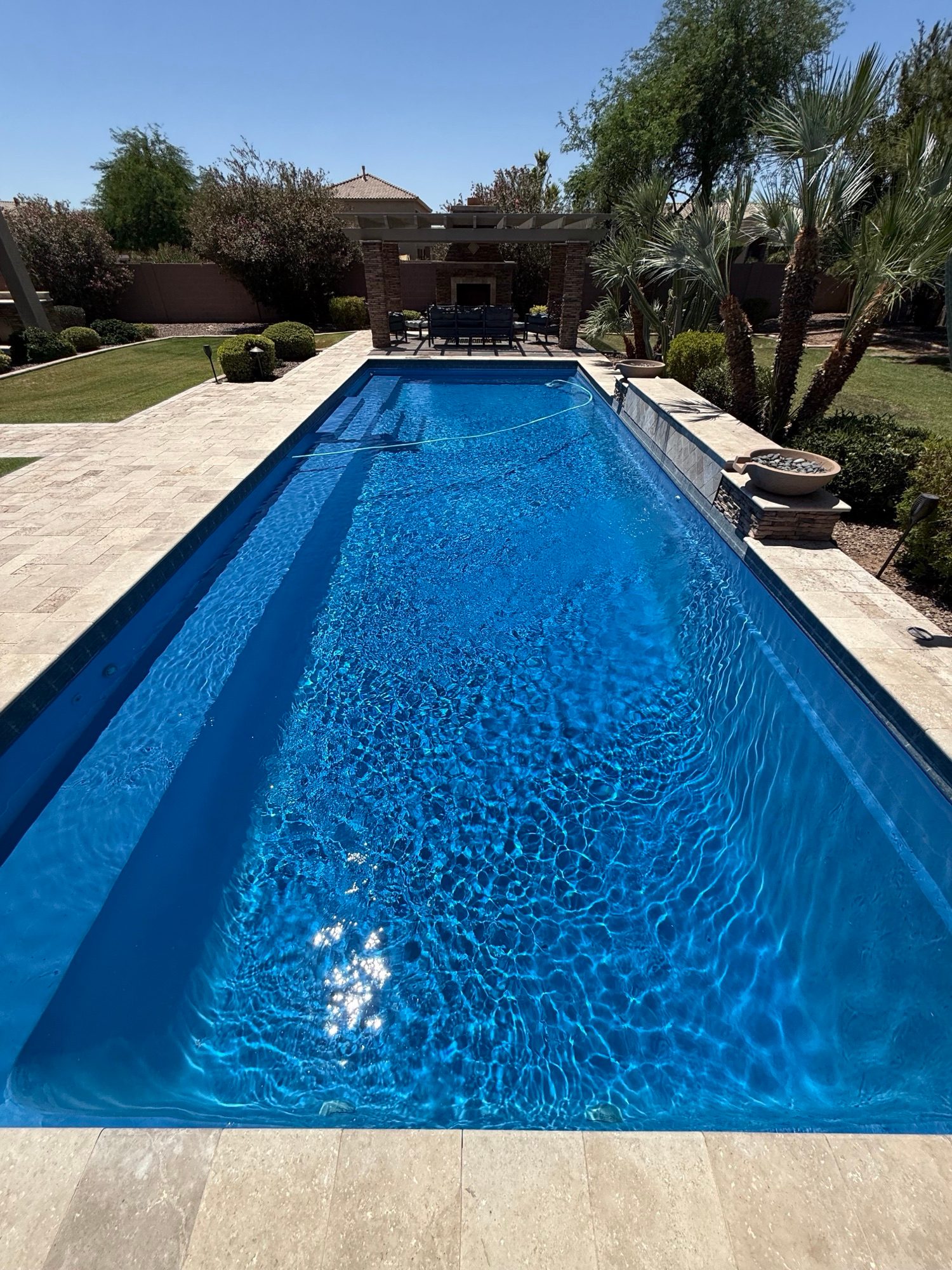 Long rectangular lap pool with deep blue, perfectly clear water